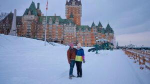 couple in snow outside Chateau Frontenac, Quebec City