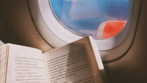 Best Books to Read on a Plane - Book and Plane Window