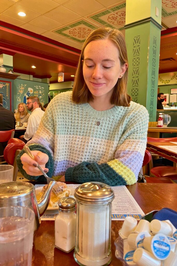 Woman eating brunch at Ann Sather's Chicago