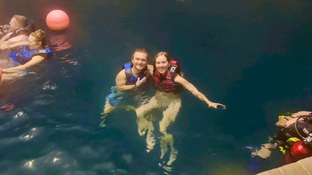 couple swimming in Homestead Crater hot spring in Utah