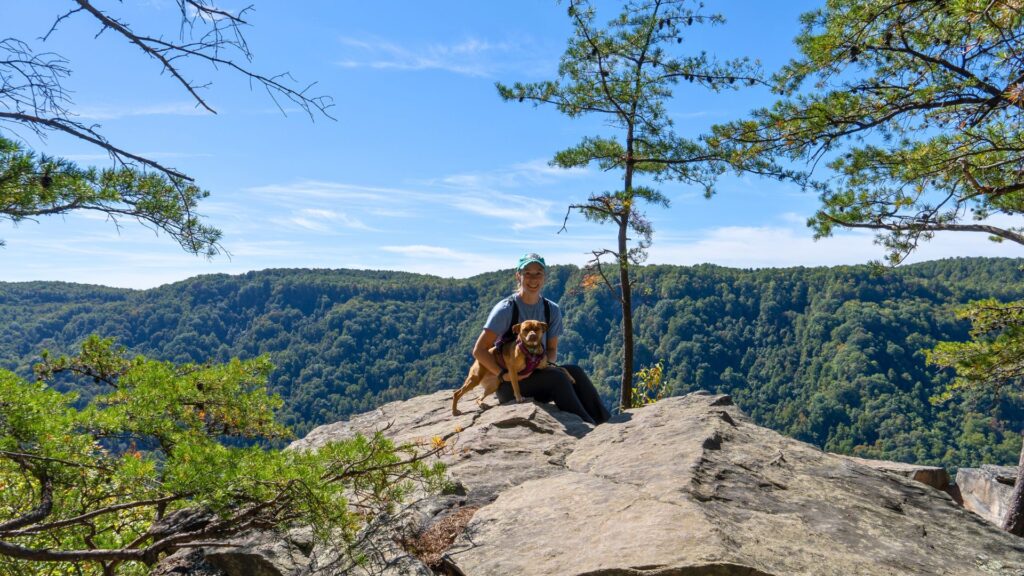 Northeast National Park Road Trip - Woman and dog posing on a hike