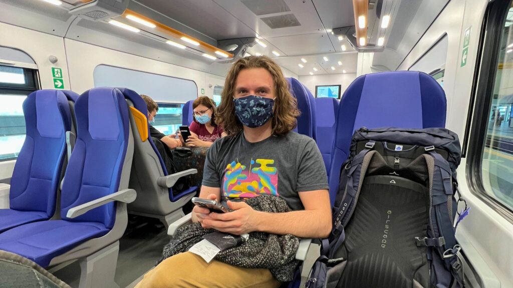 Man sitting on train from the airport to Rome in Italy