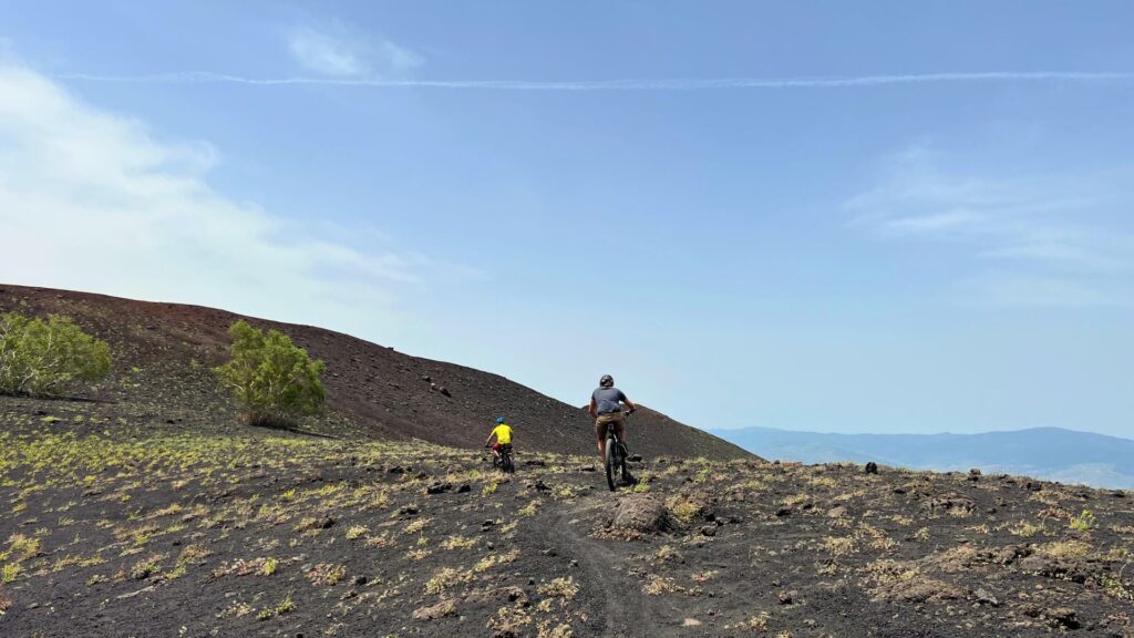 two people biking on mount etna in sicily