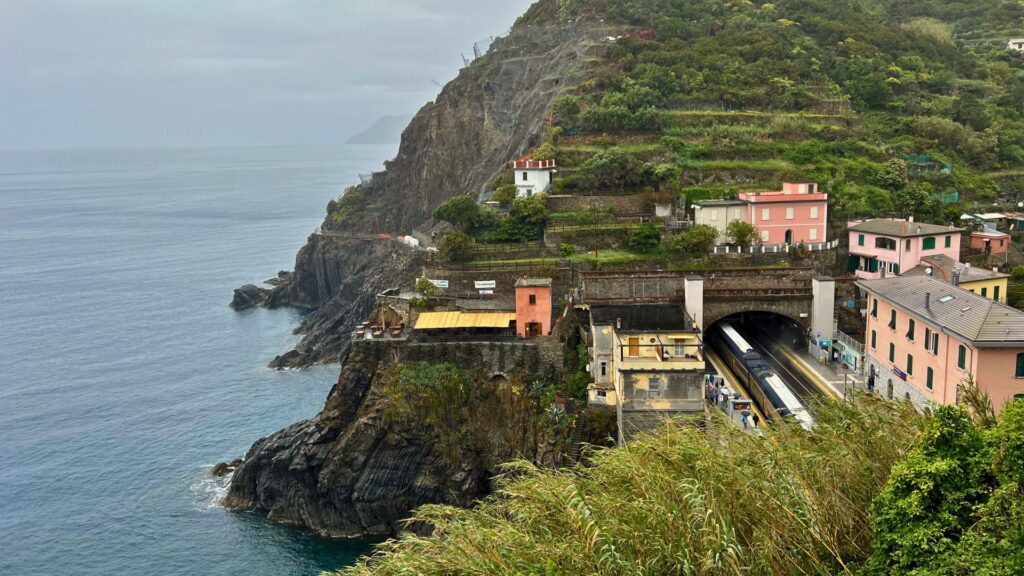 View of Riomaggiore Train Stop from the mountains in Cinque Terre Italy