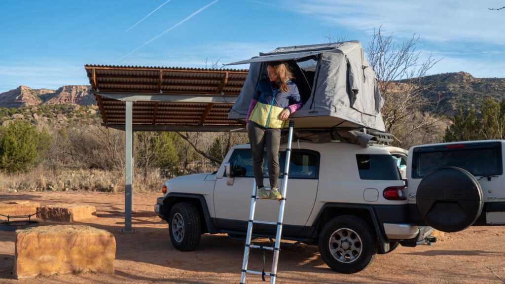 Woman and rooftop tent in Palo Duro Canyon State Park