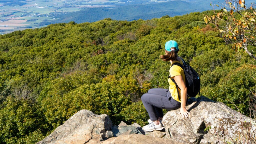 Hiker looking over Blue Ridge Mountains in Shenandoah