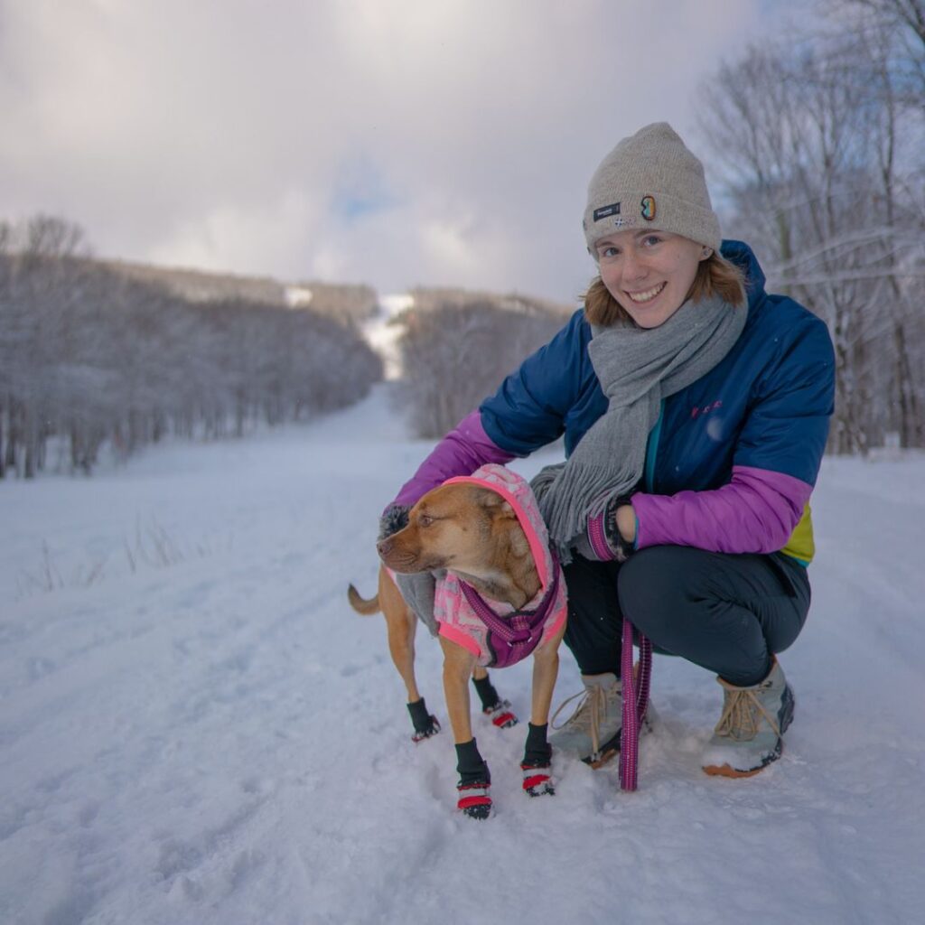 Woman and dog in the snow in Quebec