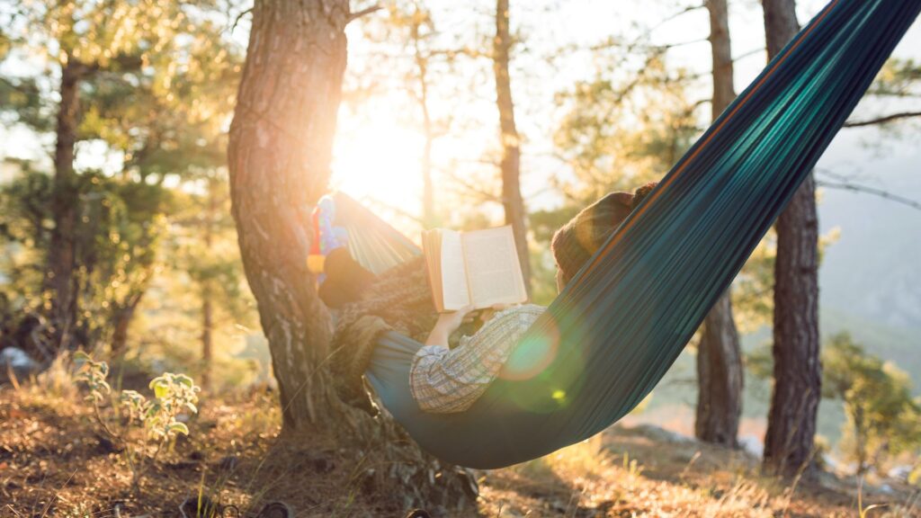 Sitting in a hammock reading