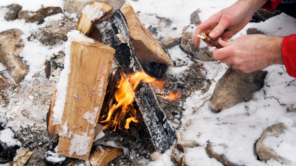 Starting a campfire in the snow