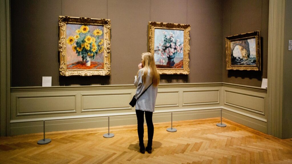 Woman admiring art museum pieces