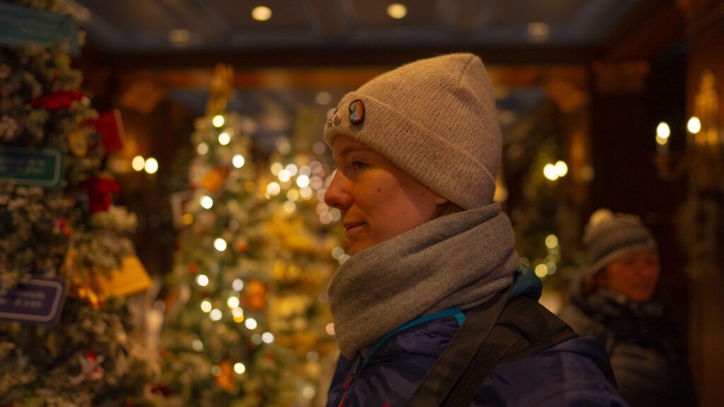 Woman in front of Christmas Lights and Trees