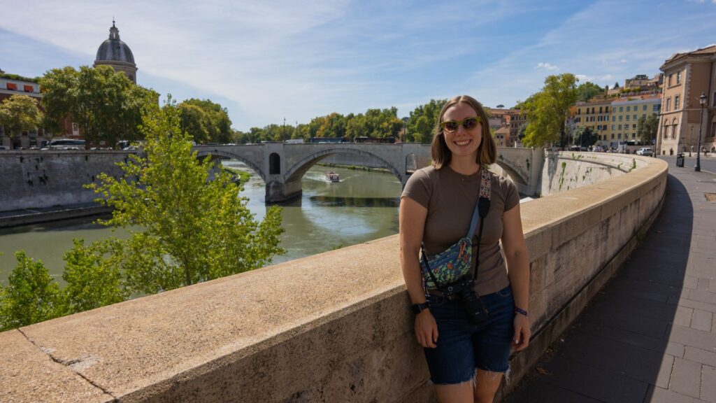 Woman standing by river in Rome Italy