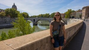 Woman standing by river in Rome Italy