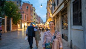 Woman posing in the street at night in Venice